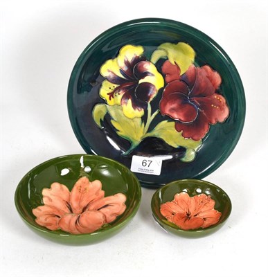 Lot 67 - Three Moorcroft pottery Hibiscus pattern bowls, 22cm, 14.5cm and 9.5cm diameters, all with...