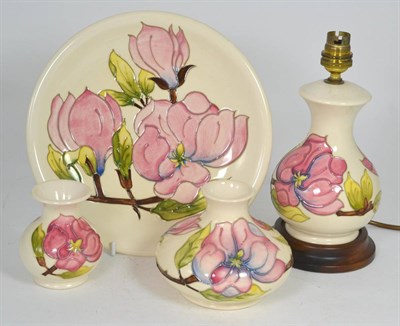 Lot 68 - A group of Moorcroft Magnolia pattern pottery comprising: a table lamp, 24cm (including...