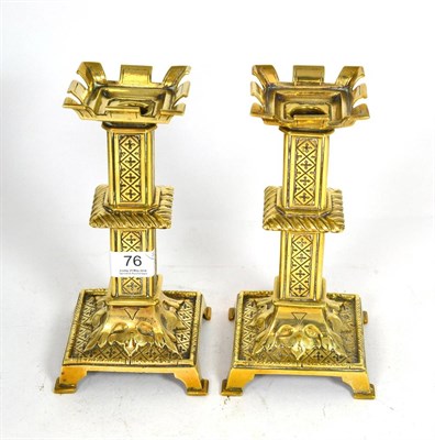 Lot 76 - A pair of 19th century brass castellated top candlesticks