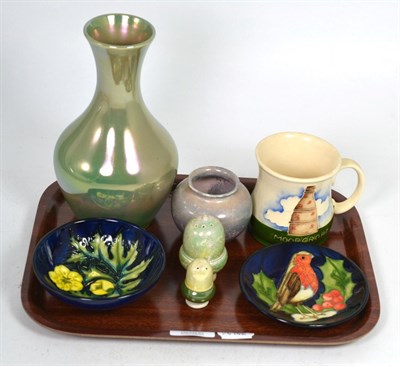Lot 124 - A group of Moorcroft pottery comprising: a 1986 year mug; a green lustre vase, 21cm; a small lustre