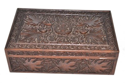 Lot 127 - An ornately carved wooden box decorated with foliage and an emblem for the Rifle Brigade