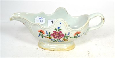 Lot 141 - A Chinese porcelain sauce boat, Qianlong, of silver shape with strap handle, painted in famille...