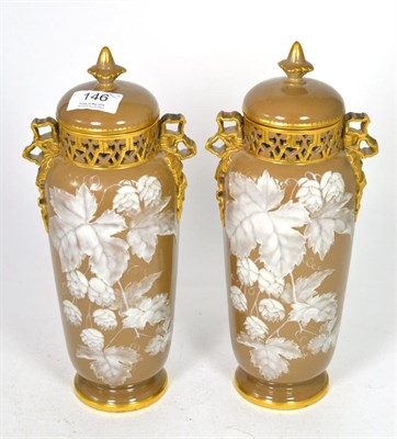 Lot 146 - A pair of Worcester vases and covers decorated with leaves