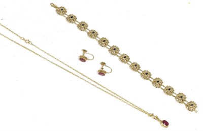 Lot 159 - A 9 carat gold ruby pendant and earring suite, an oval cut ruby in a rubbed over setting,...