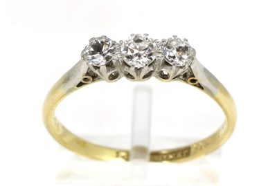 Lot 160 - A diamond three stone ring, graduated old cut diamonds in claw settings, to knife edge...