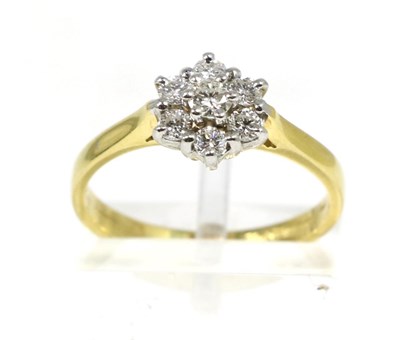 Lot 165 - An 18 carat gold diamond cluster ring, round brilliant cut diamonds in claw settings, to knife edge