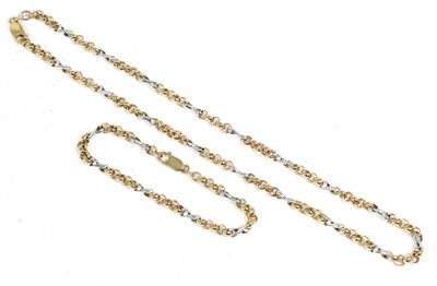 Lot 179 - A 9 carat two colour gold fancy link necklace and bracelet suite, of rose gold belcher links...
