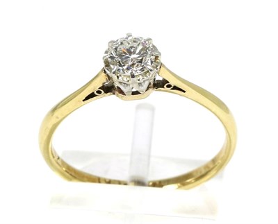 Lot 182 - A solitaire diamond ring, a round brilliant cut diamond in a claw setting above an extended...