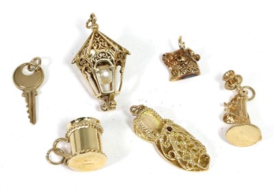 Lot 188 - Six various 9 carat gold charms, including; a bull's head, a slipper, a lantern, a telephone, a key