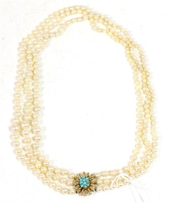 Lot 201 - A triple strand cultured pearl necklace, graduated pearls knotted to a turquoise set floral...