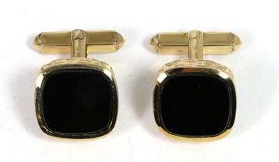 Lot 203 - A pair of 9 carat gold onyx cufflinks, oblong onyx plaques to bark textured frames, to swivel backs