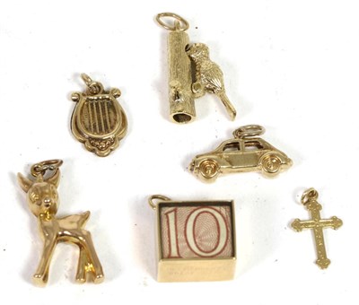 Lot 208 - Six various 9 carat gold charms, including; a woodpecker, a lyer, a cross, a fawn, a car and a note