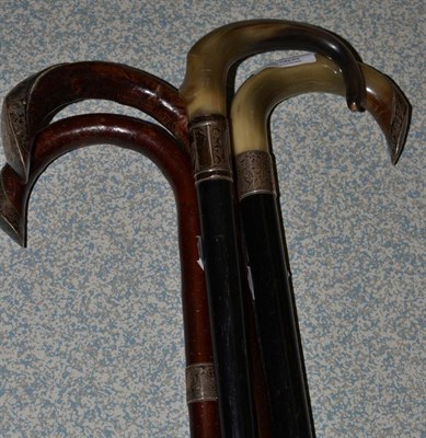 Lot 234 - Four walking sticks with silver mounts