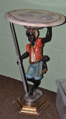 Lot 246 - A polychrome wood figure of a blackamoor, in 17th century Venetian style, standing wearing red...