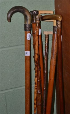 Lot 248 - Four malacca walking sticks with horn and marine ivory handles and three bamboo walking sticks with