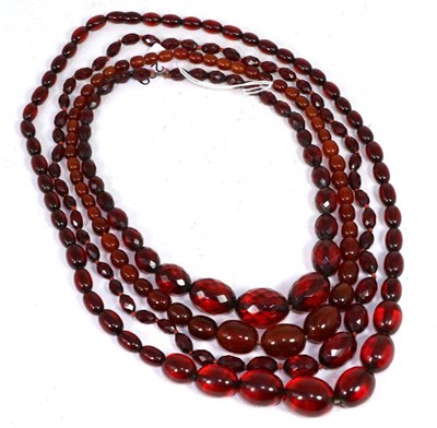 Lot 269 - Four red plastic bead necklaces, including two graduated faceted bead examples and two...