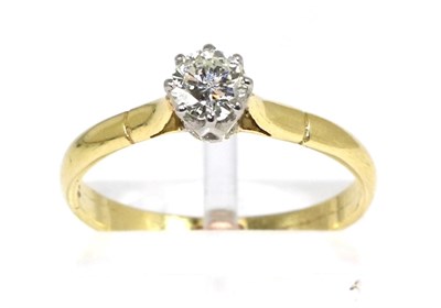 Lot 280 - A solitaire diamond ring, a round brilliant cut diamond in a claw setting, to knife edge...