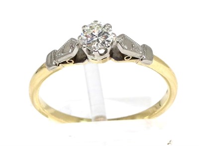 Lot 284 - A solitaire diamond ring, a round brilliant cut diamond in a claw setting, to angular...