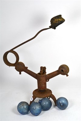 Lot 301 - A late Victorian clay pigeon trap with four glass balls, stamped N B Glassworks, Perth