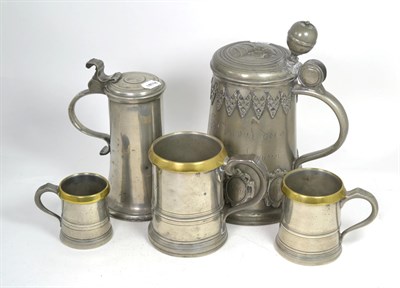 Lot 303 - An 18th/19th century pewter tankard, three 18th century pewter graduated tankards and a flagon