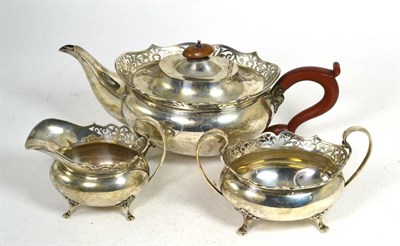 Lot 307 - A three piece silver tea service, Alexander Clark, Birmingham 1923, oval with foliate pierced...