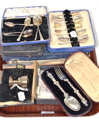 Lot 324 - Three sets of silver teaspoons, a silver egg cup; a Victorian silver gospel spoon and fork...