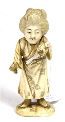 Lot 345 - A Japanese ivory okimono, Meiji period, as a geisha holding a fan and frog, 11cm high