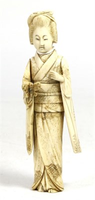 Lot 349 - A Japanese Ivory Okimono, Meiji period, as a geisha holding a butterfly, 8cm high