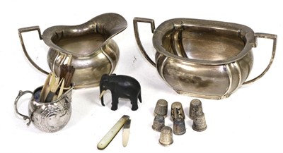 Lot 357 - A silver milk jug and sugar bowl, a silver jug and a silver thimbles