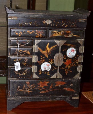 Lot 362 - A late 19th century black lacquered and gilt embellished table cabinet, two inset porcelain panels