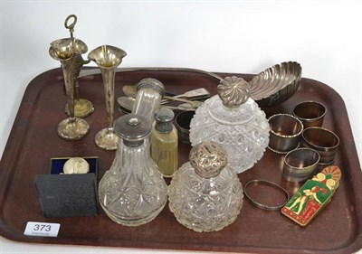 Lot 373 - A selection of silver items comprising teaspoons, napkin rings, spill vases, silver topped...