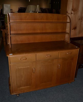 Lot 1080 - A small blonde oak Ercol dresser base and plate rack