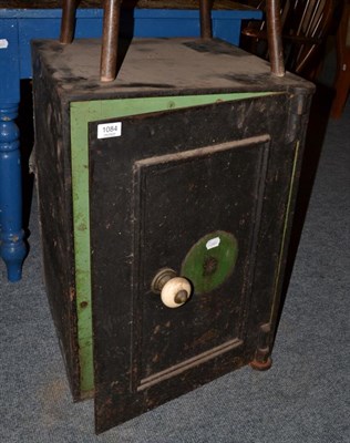 Lot 1084 - A small cast iron safe (keys lacking, but open)