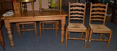 Lot 1090 - Pine kitchen table and four matching rush seated ladder back chairs