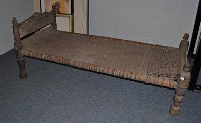 Lot 1092 - Provincial carved wooden single bed frame with cane work bedstead