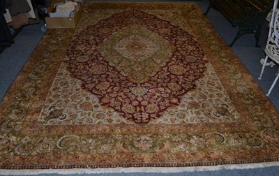 Lot 1101 - Agra design carpet, Indian, the raspberry field with vines around an olive green medallion...