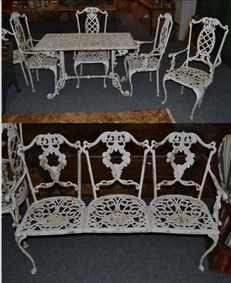 Lot 1102 - A suite of painted metal garden furniture comprising a table, four chairs and a three seater bench