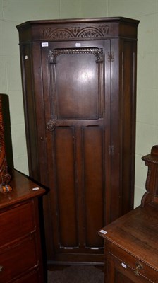 Lot 1128 - A carved oak standing wardrobe