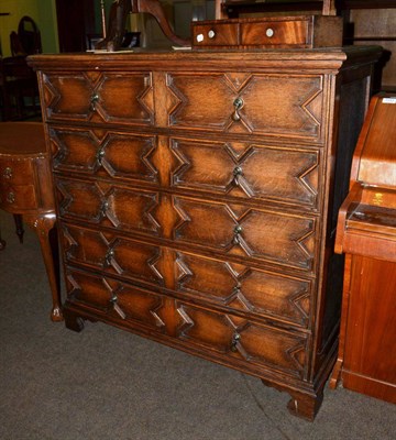 Lot 1145 - An oak geometric chest of drawers