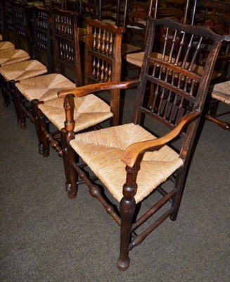 Lot 1164 - A harlequin set of eight elm rush seated spindle back chairs