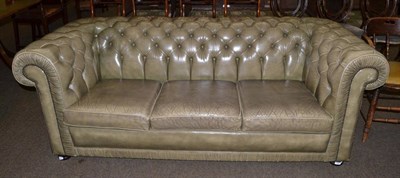 Lot 1174 - A green leather Chesterfield settee