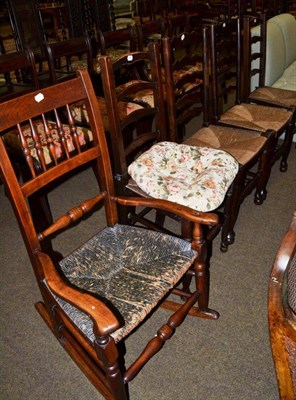 Lot 1179 - A 19th century fruitwood rocking chair; four rush seated ladder back chairs; and a ropework...