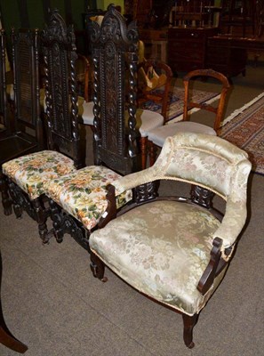 Lot 1182 - A pair of Victorian carved oak hall chairs and a Victorian tub shaped armchair