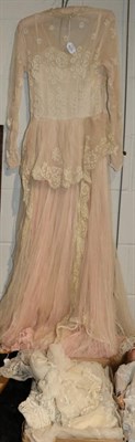 Lot 1274 - Early 20th century white net and lace mounted long sleeved dress, with pink net underskirt;...