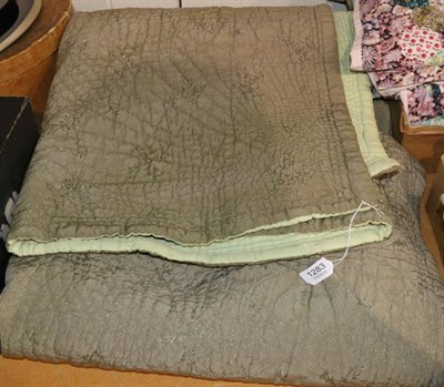 Lot 1283 - A green woven satin type quilt with green cotton reverse, 210cm by 215cm