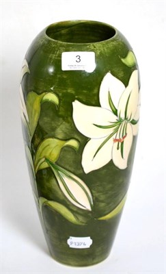 Lot 3 - A Walter Moorcroft Bermuda lily design vase, on a green ground, impressed factory marks and...