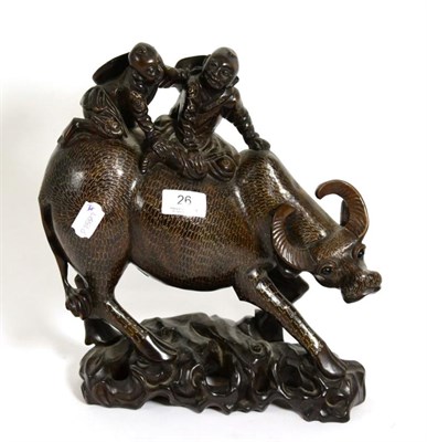 Lot 26 - A white metal inlaid Chinese hardwood model of a water buffalo carrying two children