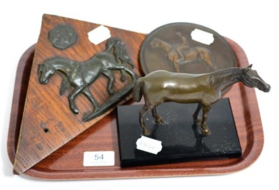 Lot 54 - A bronze model of a horse on a plinth base, together with a relief moulded plaque of a jockey...