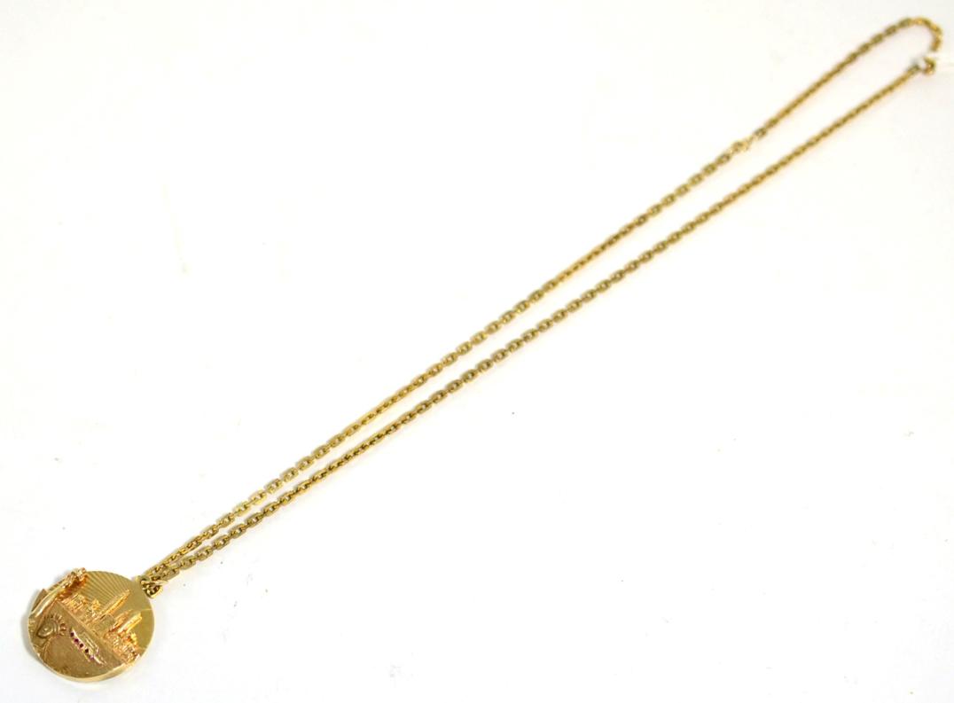 Lot 75 - An American Manhattan pendant, stamped '14K', 3.2cm diameter, on a 9 carat gold chain, length 61cm