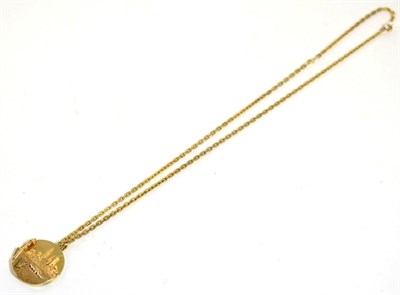 Lot 75 - An American Manhattan pendant, stamped '14K', 3.2cm diameter, on a 9 carat gold chain, length 61cm